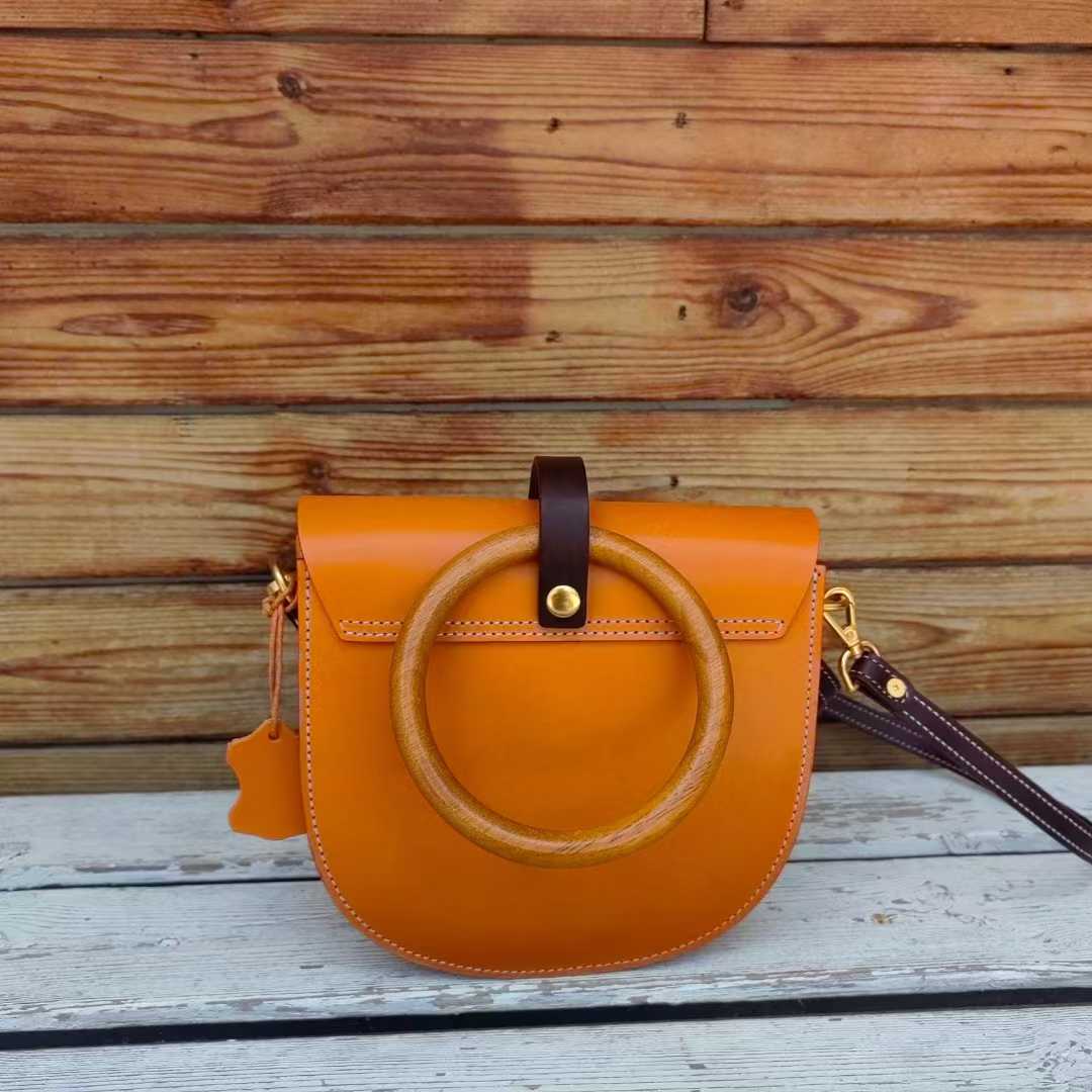Back view of orange bag showing wooden ring