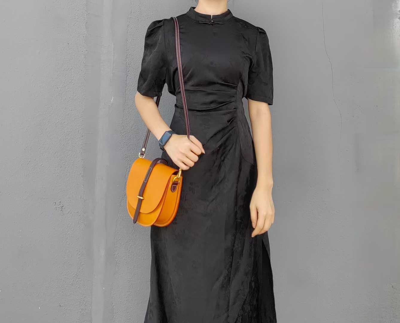 Model wearing orange bag as crossbody