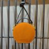 Minimalist handcrafted mini circle camera crossbody in italian veg-tan calfskin